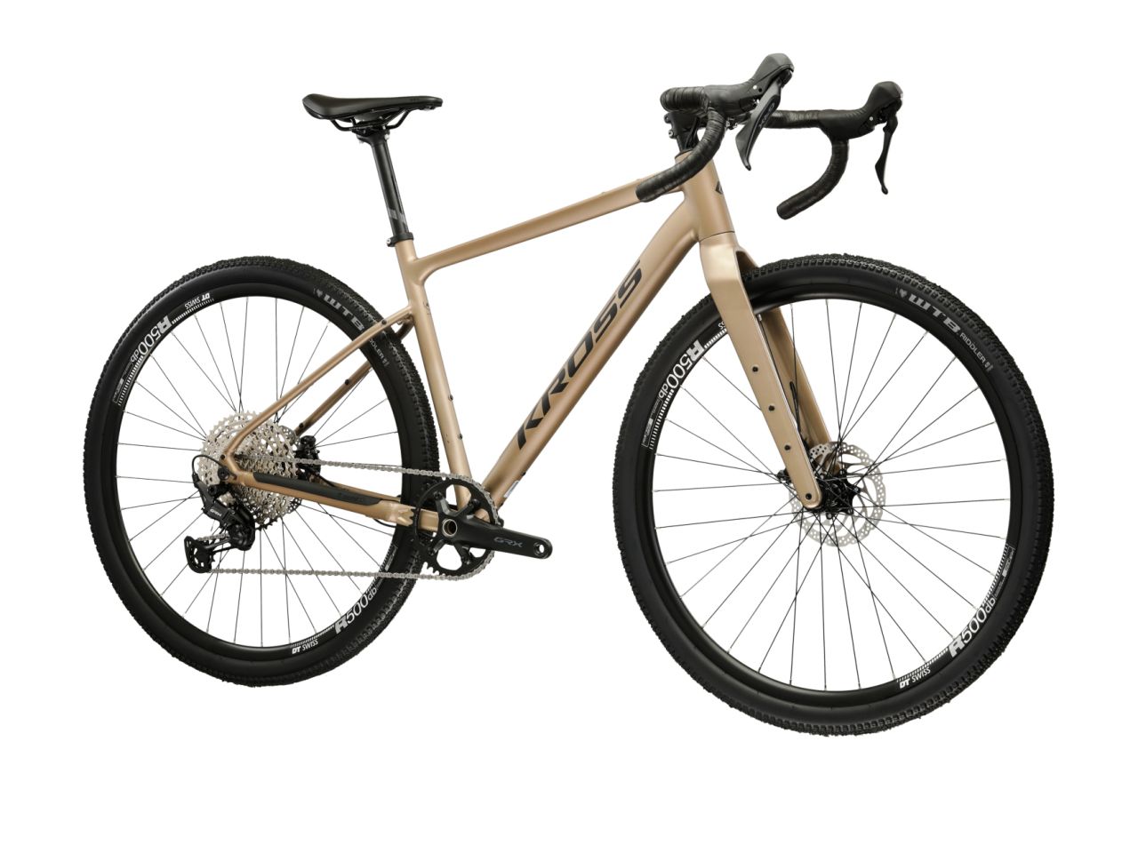Kulta-beige 12-vaihteinen, alumiinirunkoinen ja hiilikuituihaarukkainen gravel-pyörä. Kuvattu etuviistosta.