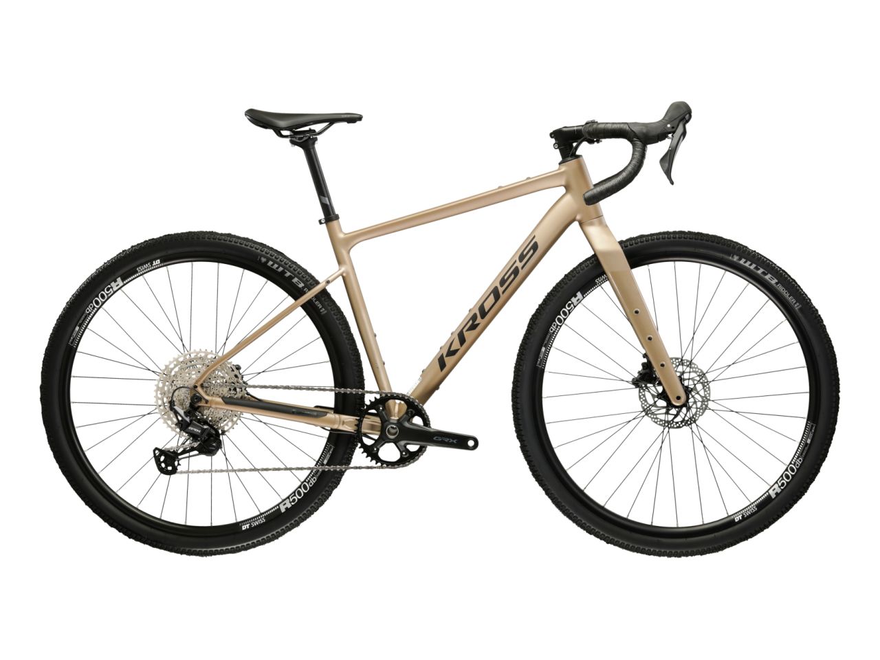 Kulta-beige 12-vaihteinen, alumiinirunkoinen ja hiilikuituihaarukkainen gravel-pyörä. Kuvattu sivulta.